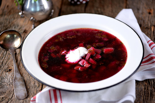 Traditional Ukrainian soup borsch on an old wooden background. Rustic style.