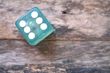one dice on wooden Background