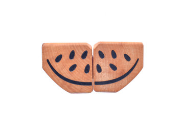 wooden watermelon slice with black seeds