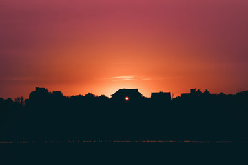 Fototapeta na wymiar Silhouette of the house at sunset