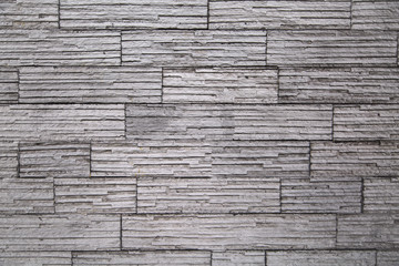 Bright gray wall of stone, horizontal stripes