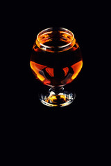 glass with cognac on a black background