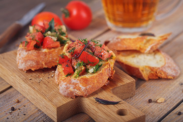 Bruschetta with chopped tomatoes, basil and herbs on grilled crusty bread.