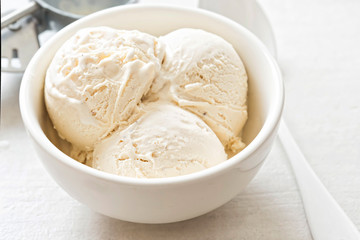 Vanilla ice cream scoops in white bowl  - 165485807