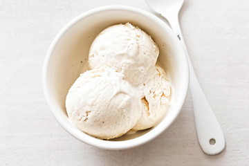 Vanilla ice cream scoops in white bowl  - 165486038