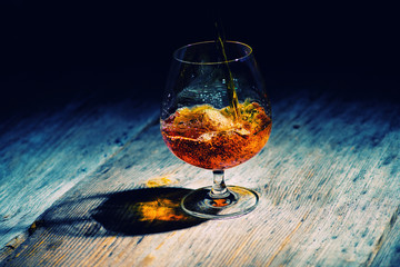 glass with cognac on a wooden background
