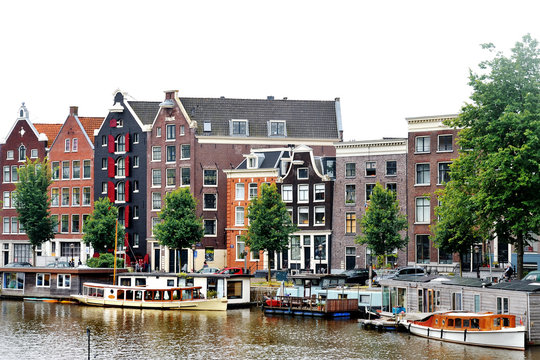Amsterdam, Holland, Europe - scenic view of the canal, boats and buildings