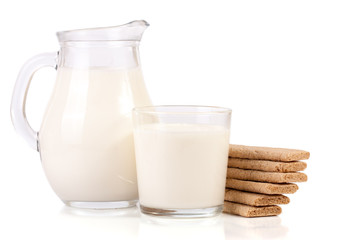 jug and glass of milk with stack of grain crispbreads isolated on white background
