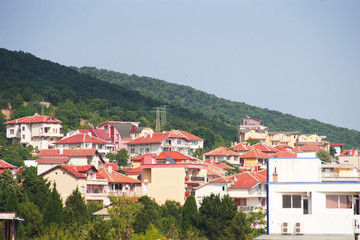 Fototapeta na wymiar Panorama of the beautiful houses and red roofs of the Balkan mountains nature Bulgaria summer resort