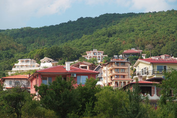 Fototapeta na wymiar Panorama of the beautiful houses and red roofs of the Balkan mountains nature Bulgaria summer resort