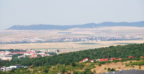 Panorama of the beautiful houses and red roofs of the Balkan mountains nature Bulgaria summer resort
