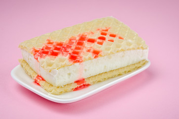wafer ice cream with syrup on a pink background/wafer ice cream with syrup
