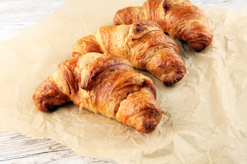 freshly baked croissants on white board, bakery concept