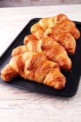 freshly baked croissants on white board, bakery concept