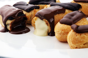 Traditional French dessert. Eclair with chocolate icing. Pastery concept