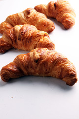 freshly baked croissants on white board, bakery concept