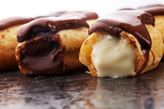 Traditional French dessert. Eclair with chocolate icing. Pastery concept