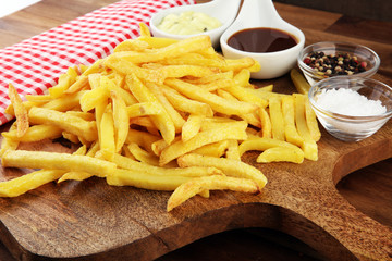 Close up Crispy Potato Fries with Two Dipping Sauce, Served on Rustic Wooden Table