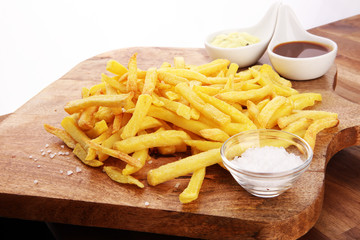 Close up Crispy Potato Fries with Two Dipping Sauce, Served on Rustic Wooden Table
