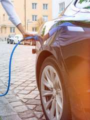 Close up of the power supply plugged into an electric car being charged