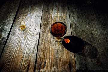 glass with cognac on a wooden background