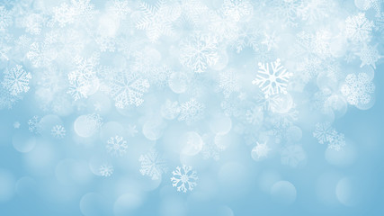 Christmas background of snowflakes with bokeh effect in light blue