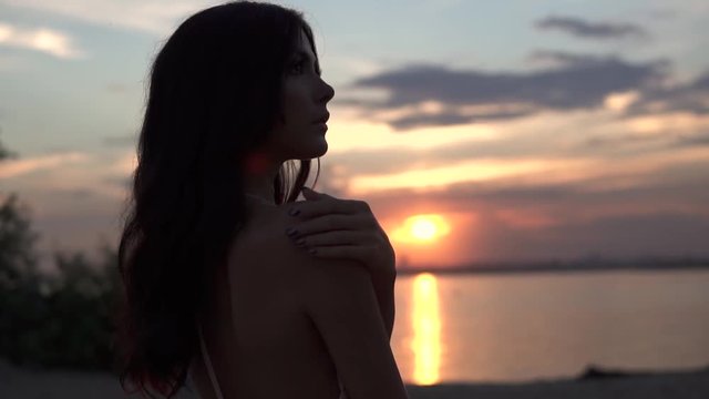 sensual closeup portrait of a beautiful girl at sunset. slow motion