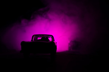 Obraz na płótnie Canvas Police car chasing a car at night with fog background. 911 Emergency response police car speeding to scene of crime.