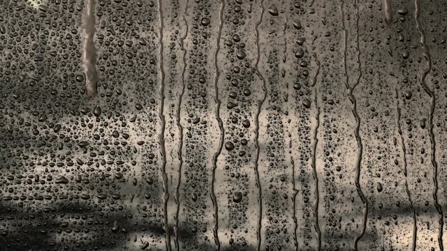 Rain drops on a glass, background, slow motion