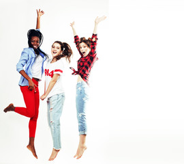 three pretty young diverse nations teenage girl friends jumping happy smiling on white background, lifestyle people concept 