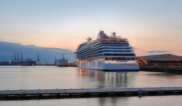 Southampton Docks At Sunset With A Variety Of Ships In Dock.