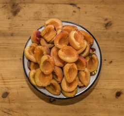 Color fresh halved apricots in bowl