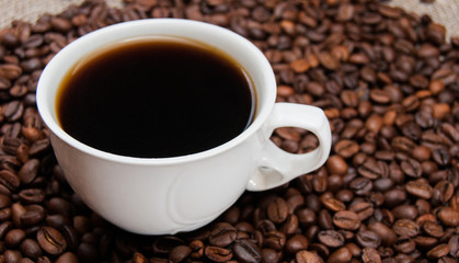 cup of coffee standing on the grains