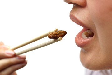 Asian female eating fried silkworms - Eating insect concept © weerapat1003