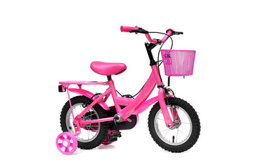 A bicycle for kid in pink color. A pink bike with training wheels on isolated background