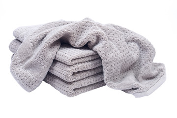 Pile, stock of thick organic cotton bath towels isolated on white background