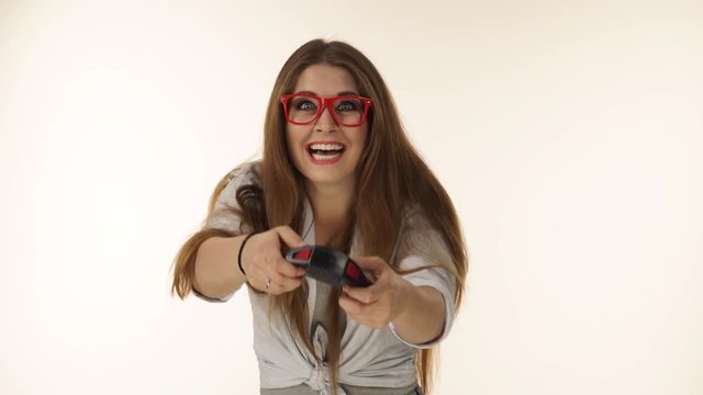 Videogame addicted girl playing with controller console. Young female gamer with pad joystick playing games. 4K ProRes HQ codec