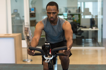 Fototapeta na wymiar African American man working out and cycling