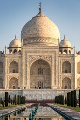 Fototapeta na wymiar View of Taj Mahal with pool reflection in Agra India at sunrise.