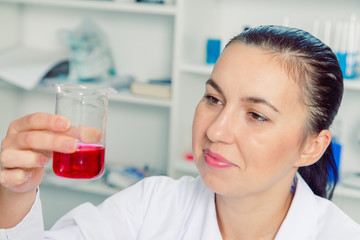 Fototapeta premium Young female scientist in lab , doing experiments in lab.