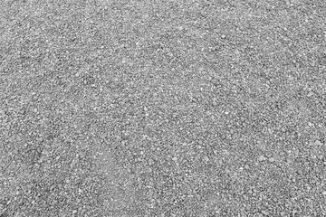 Surface of gray gravel road background.
