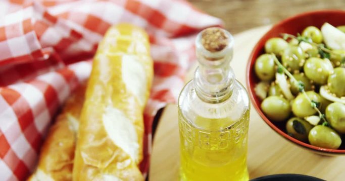 Bread, olive oil and olive tapas on table