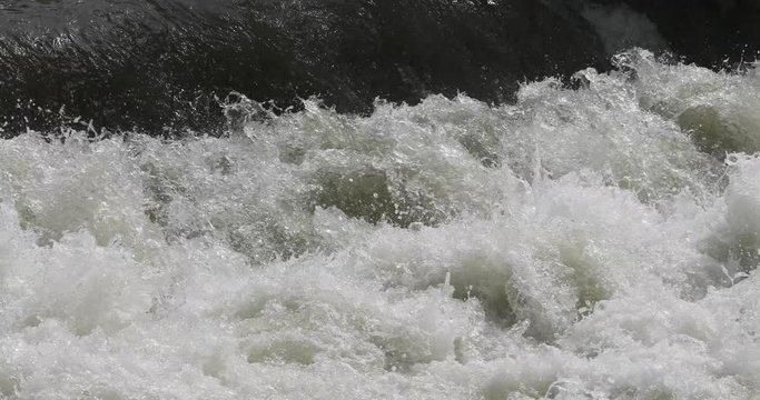 Flood river snow melt spring run off water. Beautiful clear water mountain stream, springtime snow melt. Rocks and fallen timber logs in waterfalls. Forest nature in natural environment. Little Cott