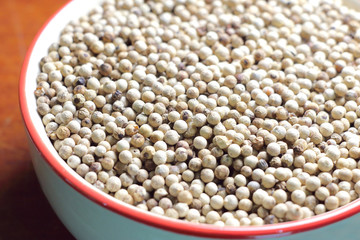 Fototapeta premium white pepper seeds in bowl used as a condiment.