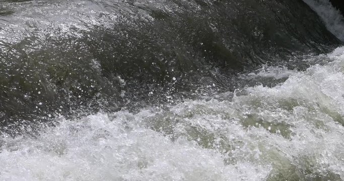 Flood water raging river splash. Beautiful clear water mountain stream, springtime snow melt. Rocks and fallen timber logs in waterfalls. Forest nature in natural environment. Little Cott