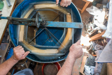 Blue Handy Extractor with honey comb. Use of a centrifugal extractor leaves the cells of the comb intact because you need only remove the pure wax cap that indicates finished honey