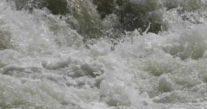 Raging flood waters river natural danger. Beautiful clear water mountain stream, springtime snow melt. Rocks and fallen timber logs in waterfalls. Forest nature in natural environment. Little Cott