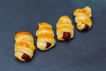 Home made pigs in a blanket. Sausages rolled in croissant dough