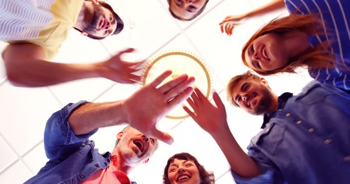 Upward view of happy executives forming handstack