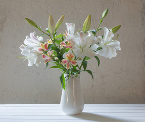 beautiful white lily in vase on background old wall